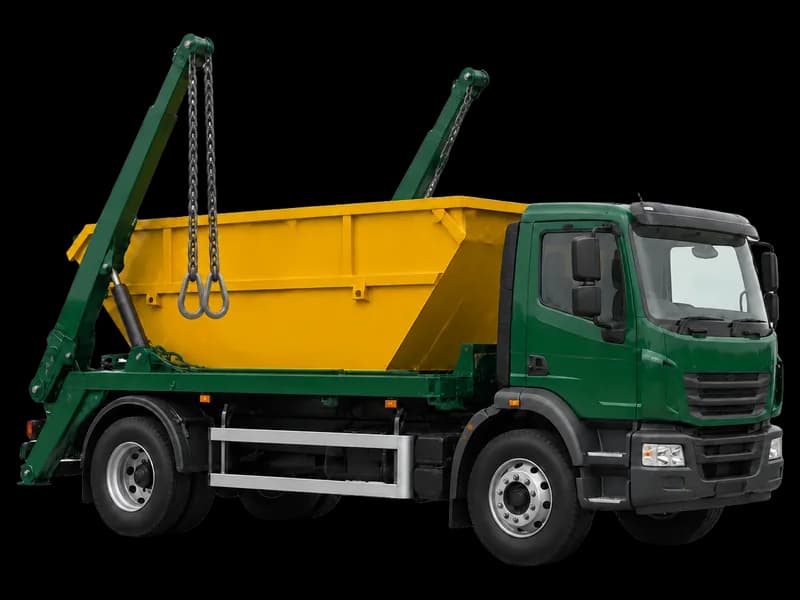 Skip loader carrying a yellow skip