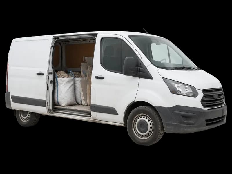 Van with building waste beside it